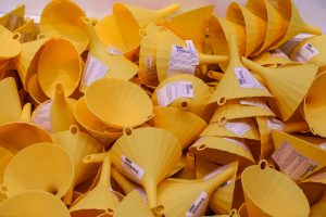 A pile of yellow plastic cups and bowls